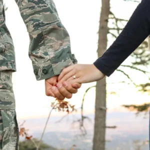 A picture of a soldier holding the hands of his fiancee